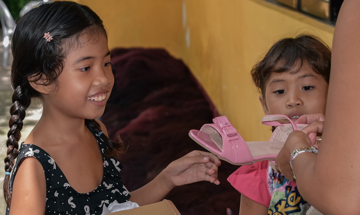 Christmas in the Philippines - gift of shoes for child