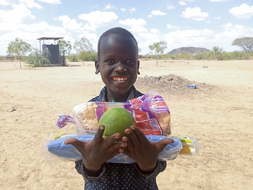 Kenya Hope Centers Christmas celebration boy with gifts