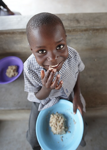 Christmas in Zimbabwe smiling boy eating