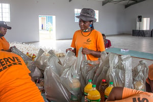 Child Champions pack food to help families in Zimbabwe feed their children.