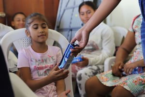 Girl receiving toothpaste and toothbrush