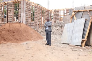 Bishop Lomonyak in front of a building that is currently being constructed at his church compound The building will serve as a cathedral