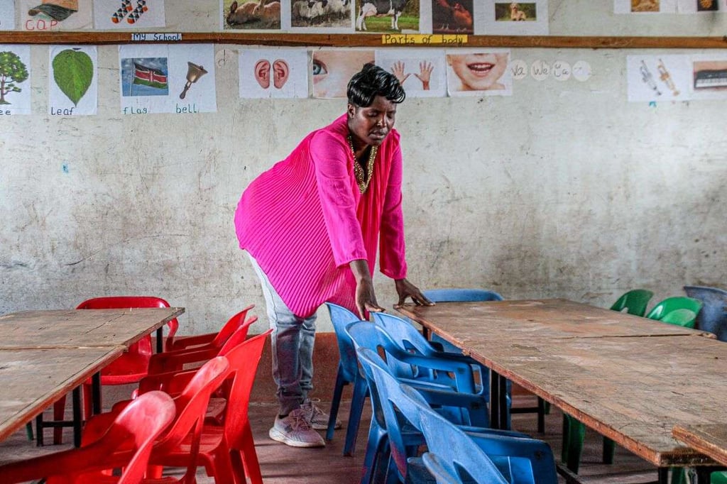 Esther praying while touching desks