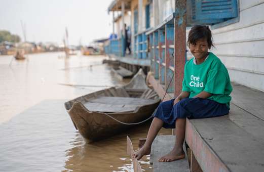 Young girl sitting on floating school