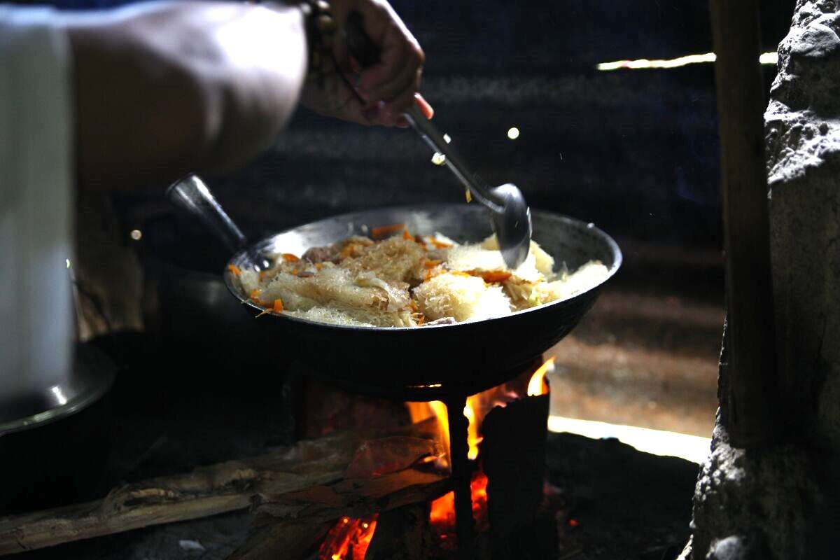 Pancit bihon noodles are mixed with other ingedients until it turns translucent color meaning it is done