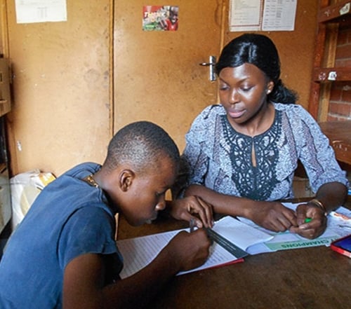 Tatenda helping a student