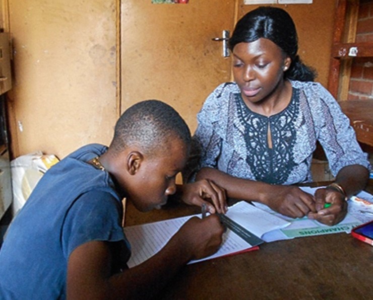 Tatenda helping a student