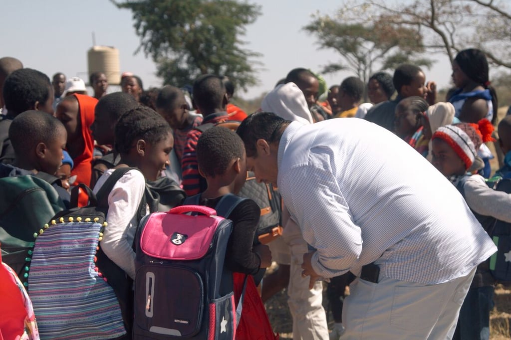 Pastor Eliut distributing backpacks